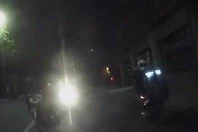 The video shows the bikes wheelying up behind the car.
