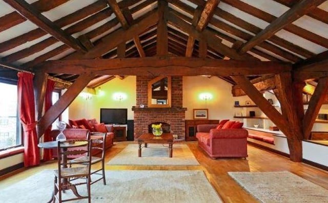 The first floor lounge with feature brick fireplace and open beams.