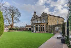 The impressive period property stands within private, landscaped gardens.