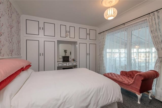 This double bedroom within the property has a range of fitted furniture.