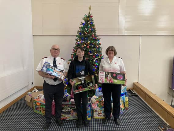 Oscar with his donations for The Salvation Army Christmas Present Appeal. Pictured with Majors Paul and Carolyn Wilson.