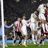 Striker Dominic Calvert-Lewin wins a header in his own box in Leeds United's game with Brentford.
