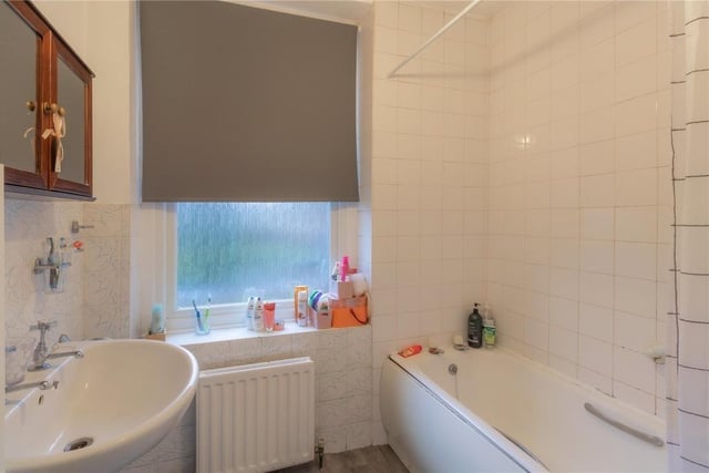 The family bathroom includes a bath with shower over, and has scope for improvement.