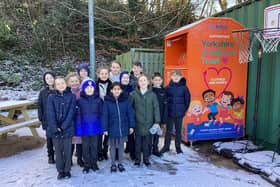 The young 'eco heroes' at Hanging Heaton Junior and Infant School with the clothing bank