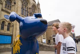 Pictured with Kirkwood hospice Snowdog sculptures are Byron Taylor, 10, and Marnie Taylor seven, outside the Longcauseway Church, Dewsbury. The Kirkwood has teamed up with Kirklees Libraries to offer half-term activities from Monday, October 24, until Sunday, October 30.