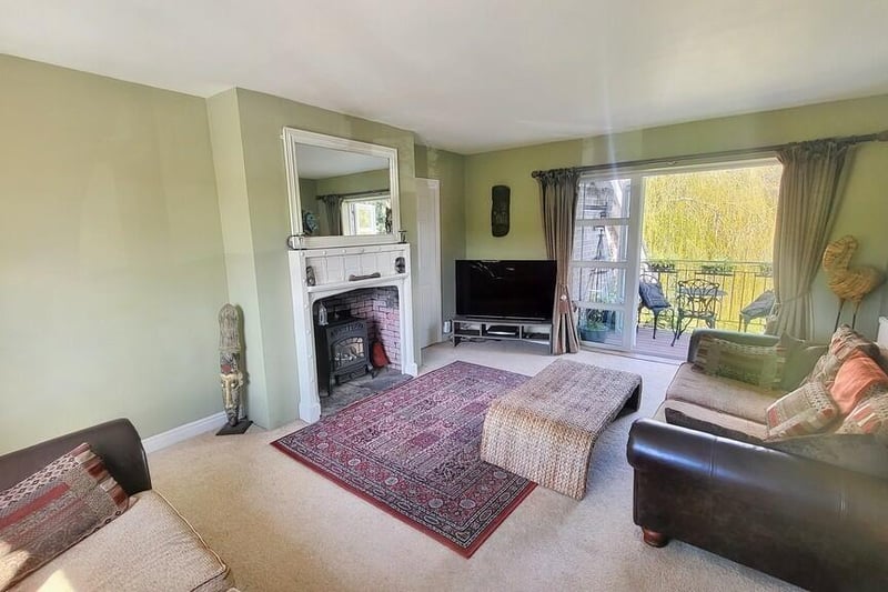 This dual aspect lounge features a gas stove effect fire with slate hearth, a brick back and wood surround and doors to master bedroom and French doors which lead to the balcony.