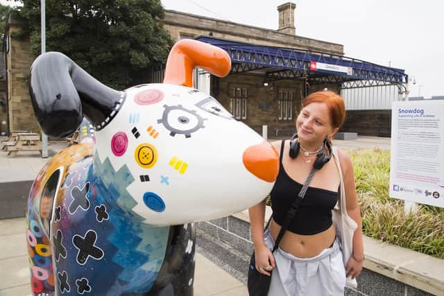 Danielle Wilcock with the Snowdog outside Dewsbury Train Station.