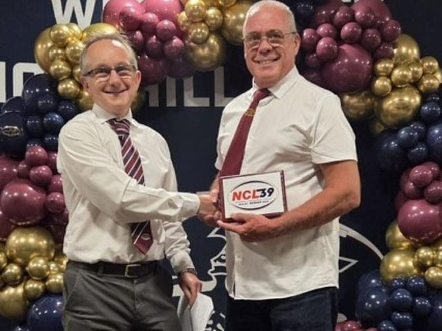 Andrew Smith accepting the NCL plaque.