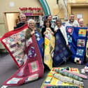 Joanne Cook and volunteers with the patchwork quilts at Batley Library.