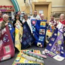 Joanne Cook and volunteers with the patchwork quilts at Batley Library.