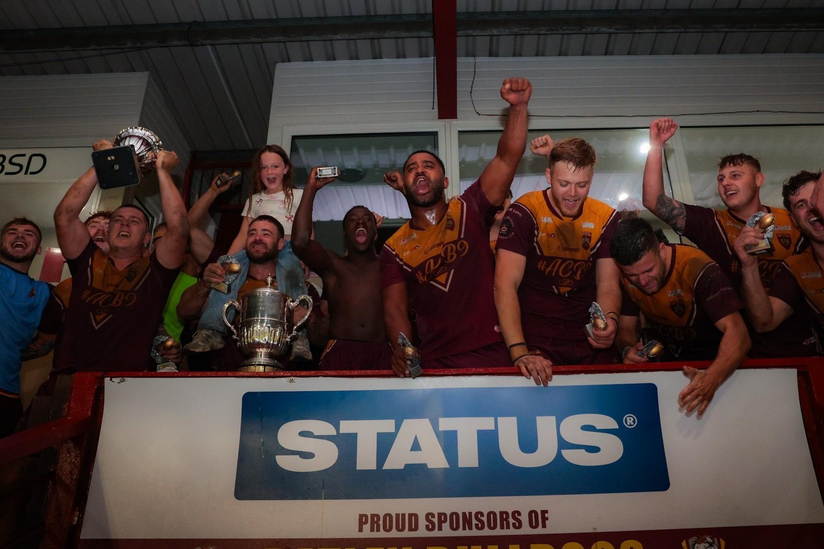 Dewsbury Moor Maroons' winning team celebrate after their Jim Brown Challenge Cup final success.