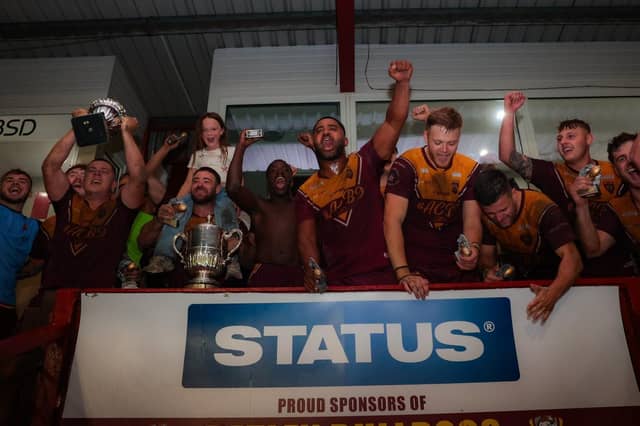 Dewsbury Moor Maroons' winning team celebrate after their Jim Brown Challenge Cup final success.