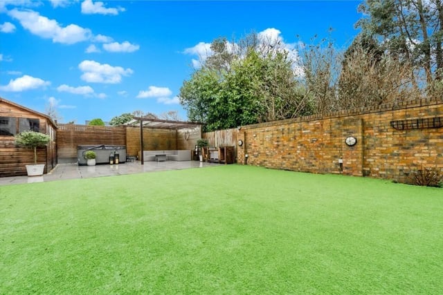 The rear lawned garden is landscaped with two large seating areas.