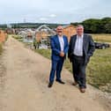 Coun Shabir Pandor, Leader of Kirklees Council, and Coun Graham Turner, cabinet member for growth and regeneration, on a pathway in front of several of the allotments