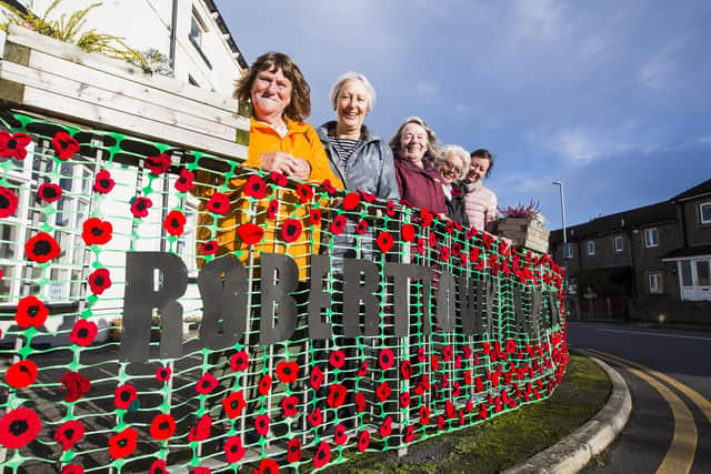 Suzan Parratt, Anne Day, Sheila Brooke, Pat Holliday and Louise Rawstron, with the knitted Remembrance banner.