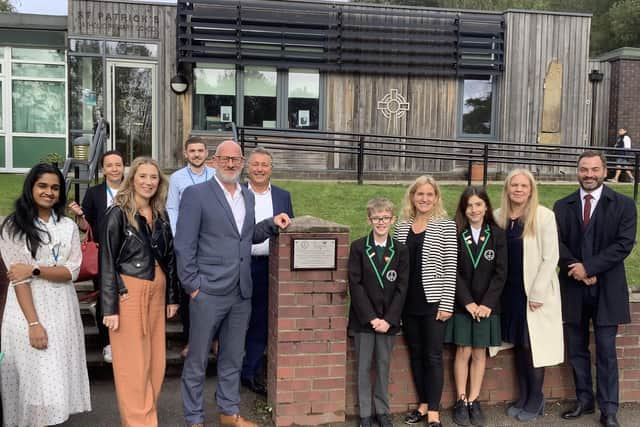 Staff and pupils at St Patrick’s Catholic Primary Academy in Birstall, with Batley and Spen MP, Kim Leadbeater, and Matthew Baines, PPG General Manager, at the unveiling of a plaque to commemorate the newly tranformed play area.