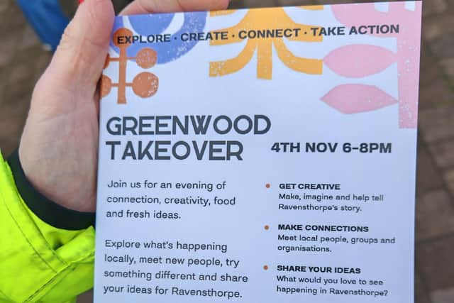 A police officer holding a leaflet for the event at the Greenwood Centre.