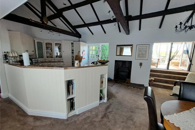 The beamed and fitted kitchen also has a log burner stove with a Yorkshire stone hearth.