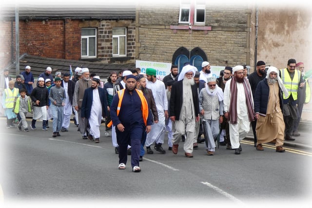 The procession heads towards Westtown after passing Dewsbury Health Centre