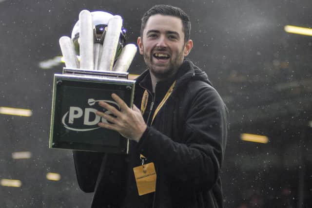 Leeds United fan and recently crowned World Darts champion Luke Humphries parades the PDC trophy he won to the Elland Road crowd at half-time of the Preston game.