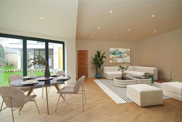 This irregular shaped room has ample natural light from full height windows and bi-folding doors leading to garden.