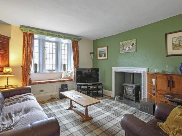 A cosy, carpeted room with a window seat