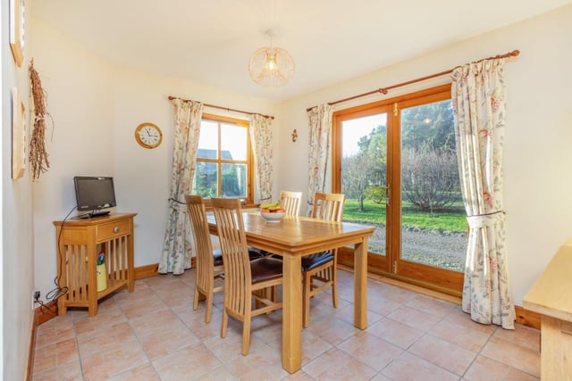The dining room shares a semi open-plan space with the kitchen and benefits from French doors leading to the garden.