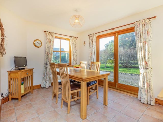 The dining room shares a semi open-plan space with the kitchen and benefits from French doors leading to the garden.