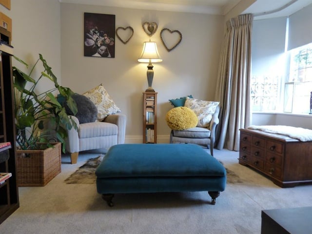 This sitting room also has a front bay window that fills it with natural light.