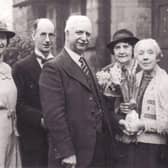 Nostalgia with Margaret Watson: Dan and Harriet Oldroyd (far right) are pictured at their home, 4 Fletcher Homes, with their presentation from members of Dewsbury Council and Parks Department in 1936 to mark their golden wedding anniversary.