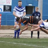 Caelum Jordan dives over for a try for Dewsbury Rams at Workington.