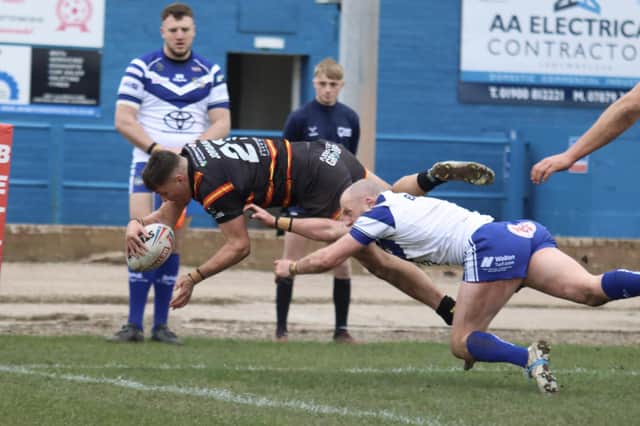 Caelum Jordan dives over for a try for Dewsbury Rams at Workington.