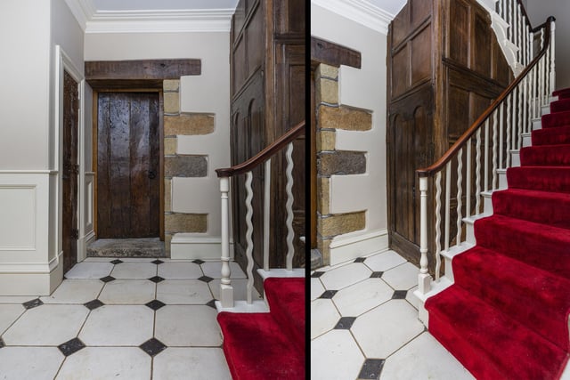 A feature staircase takes you up to the first and second floors from the panelled hallway.