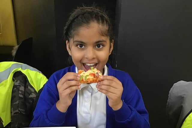 A Warwick Road Primary School pupil enjoying her pizza.