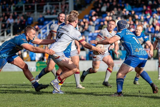 Batley's Jimmy Meadows puts Alistair Leak in to score his second try at Barrow. Picture: Neville Wright