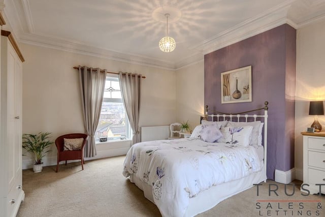 One of the property's spacious double bedrooms with a feature window.