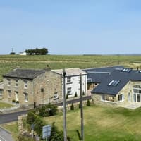 Contemporary home in open countryside blends industrial character with rural charm