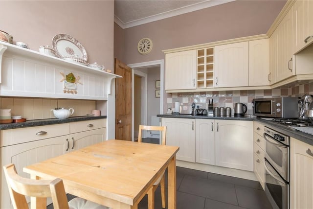 A sizeable and well equipped kitchen has room for a dining table and chairs.
