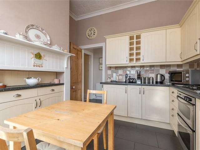 A sizeable and well equipped kitchen has room for a dining table and chairs.
