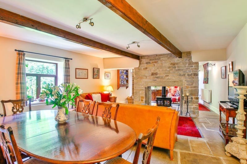 The dining and snug has Yorkshire stone flooring and a double sided fireplace with cast iron stove.