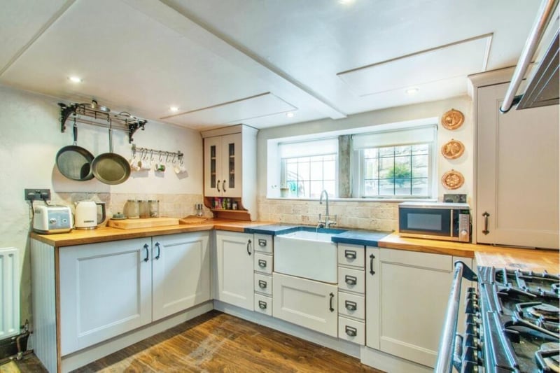 The kitchen has a classic Belfast sink, and solid wood units and counter tops.