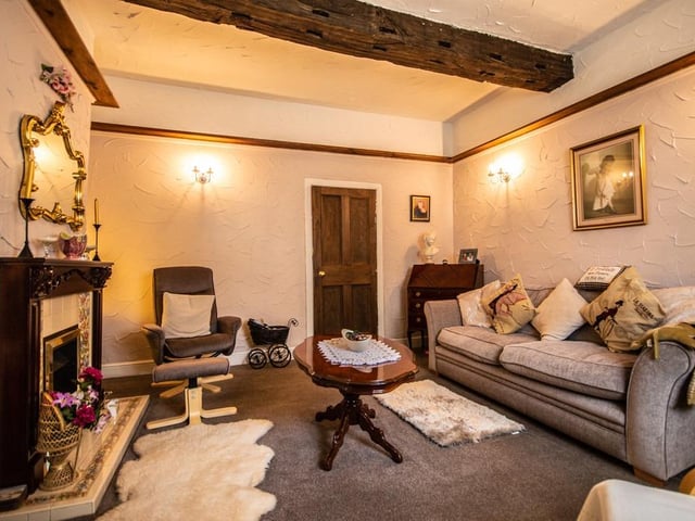 Inside the hall and its beamed lounge with central feature fireplace.