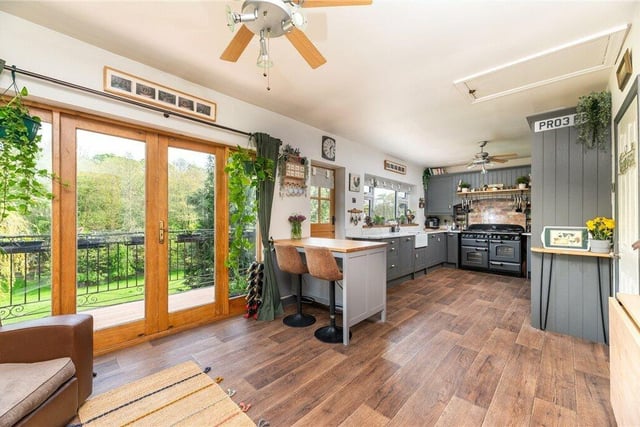 The spacious breakfast kitchen has doors out to a balcony overlooking the grounds.