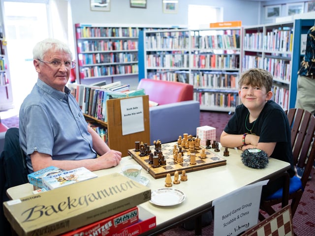 Ken Rogers and Isaac Smethurst play chess at Mirfield Library's 75th birthday party.