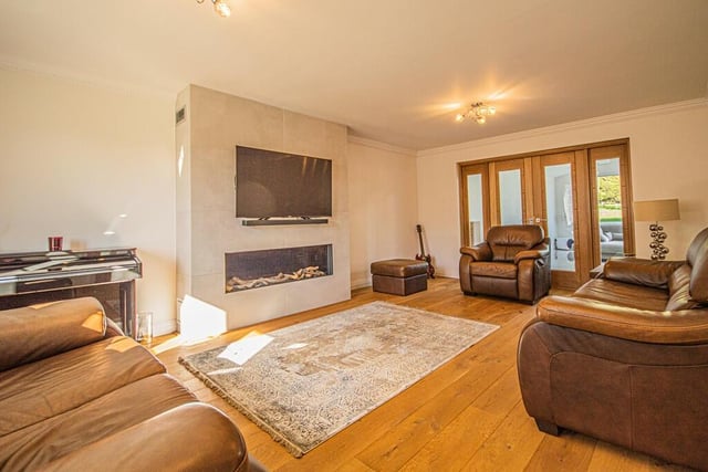 This sitting room with feature gas fire has oak flooring.