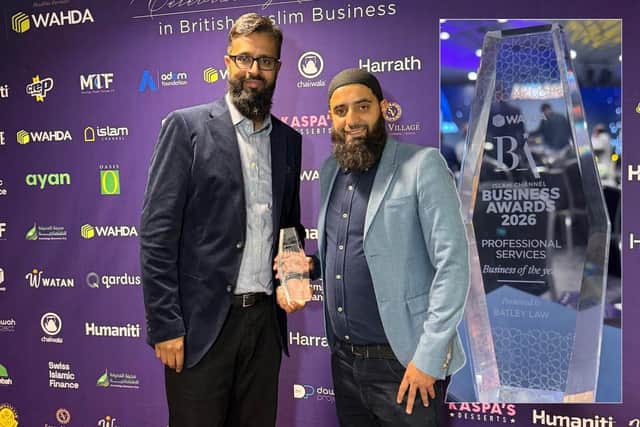 Batley Law directors Waseem Nazir, left, and Hassnain Sajjad holding their award.