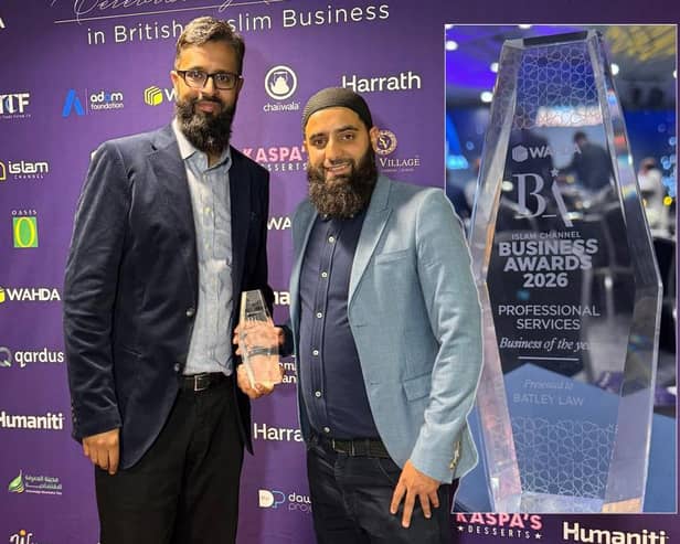 Batley Law directors Waseem Nazir, left, and Hassnain Sajjad holding their award.