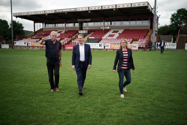 Batley Bulldogs' chairman Kevin Nicholas, left, and Kim Leadbeater MP, right, with Labour Party leader Keir Starmer on the Mount Pleasant pitch during a visit to Batley Bulldogs.