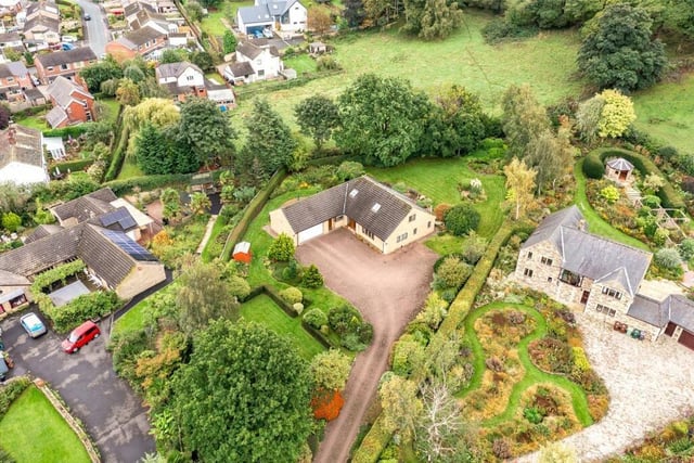 An aerial view of the detached bungalow and its gardens.