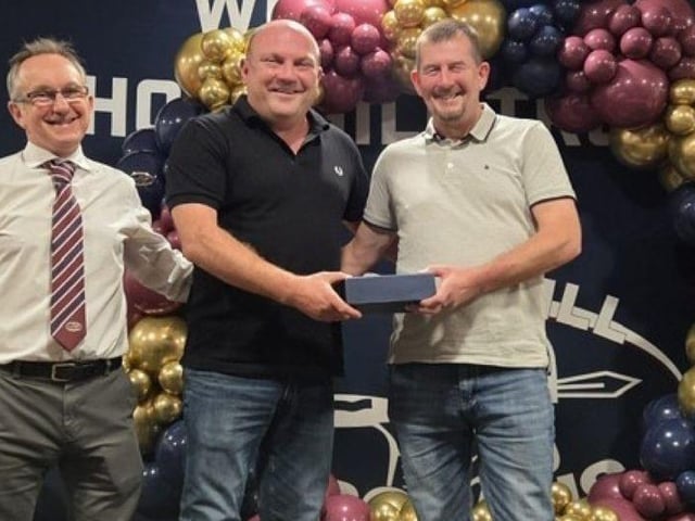 Steve Raine receives the Master of Stone from Masters team manager Adam France.
